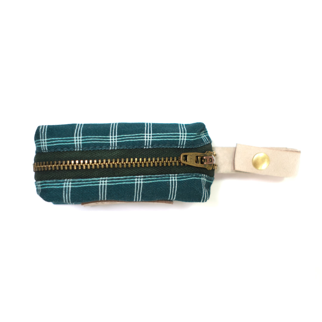 Dark teal plaid dog waste bag holder shown from top