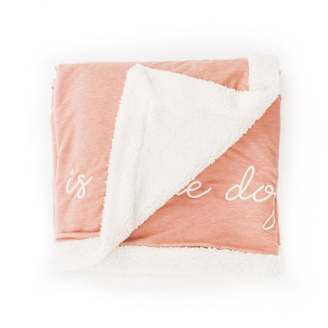 Blush fleece blanket with The Doggy Snuggle is Real embroidered on front and natural Sherpa back side folded with corner back